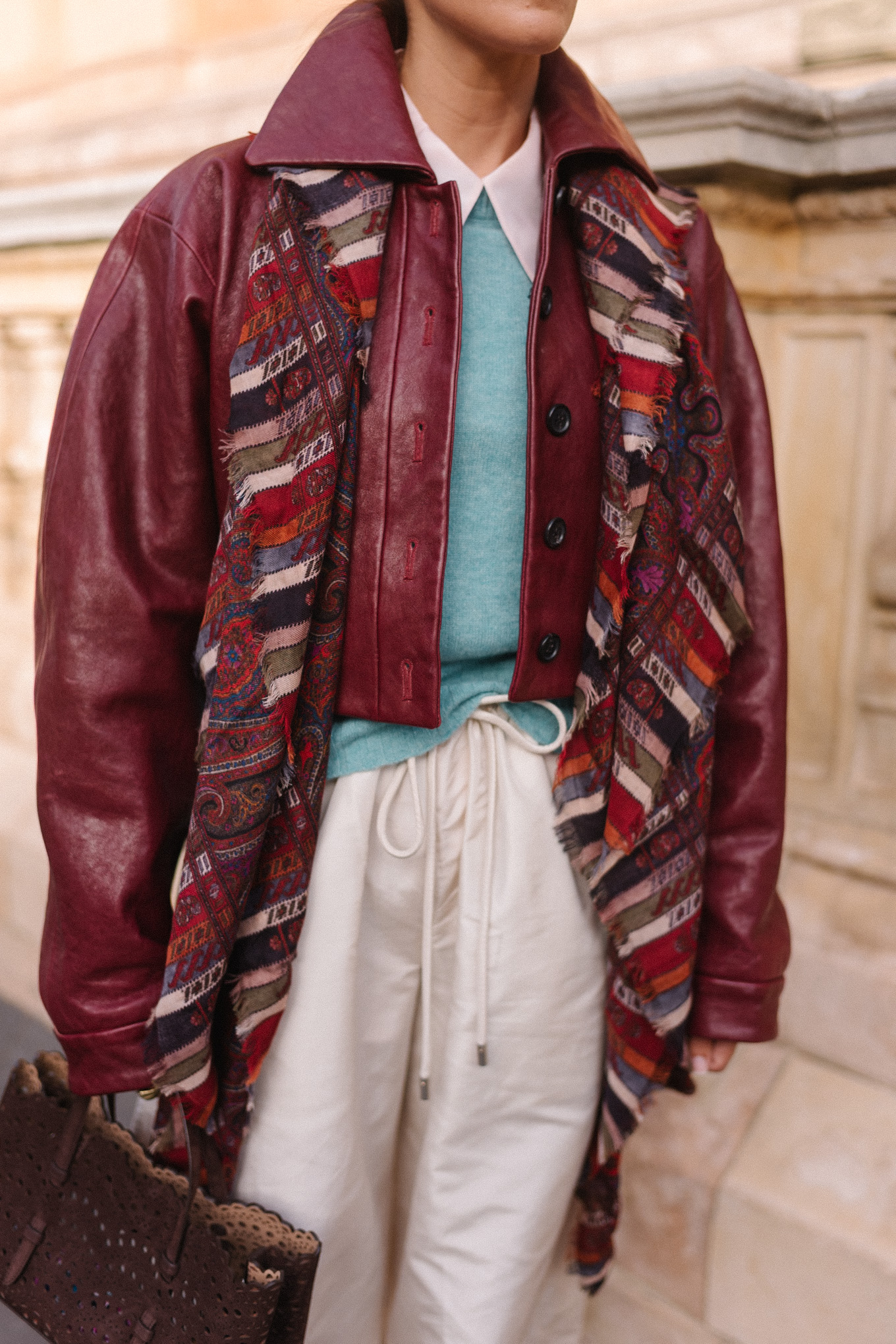 maroon leather jacket striped scarf turquoise sweater white button down shirt cream wide leg pants