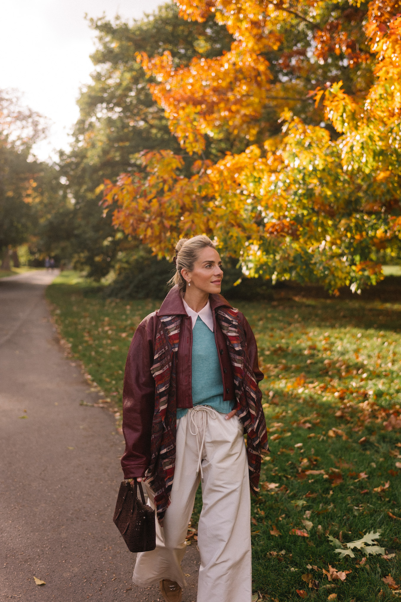 maroon leather jacket striped scarf turquoise sweater white button down shirt cream wide leg pants