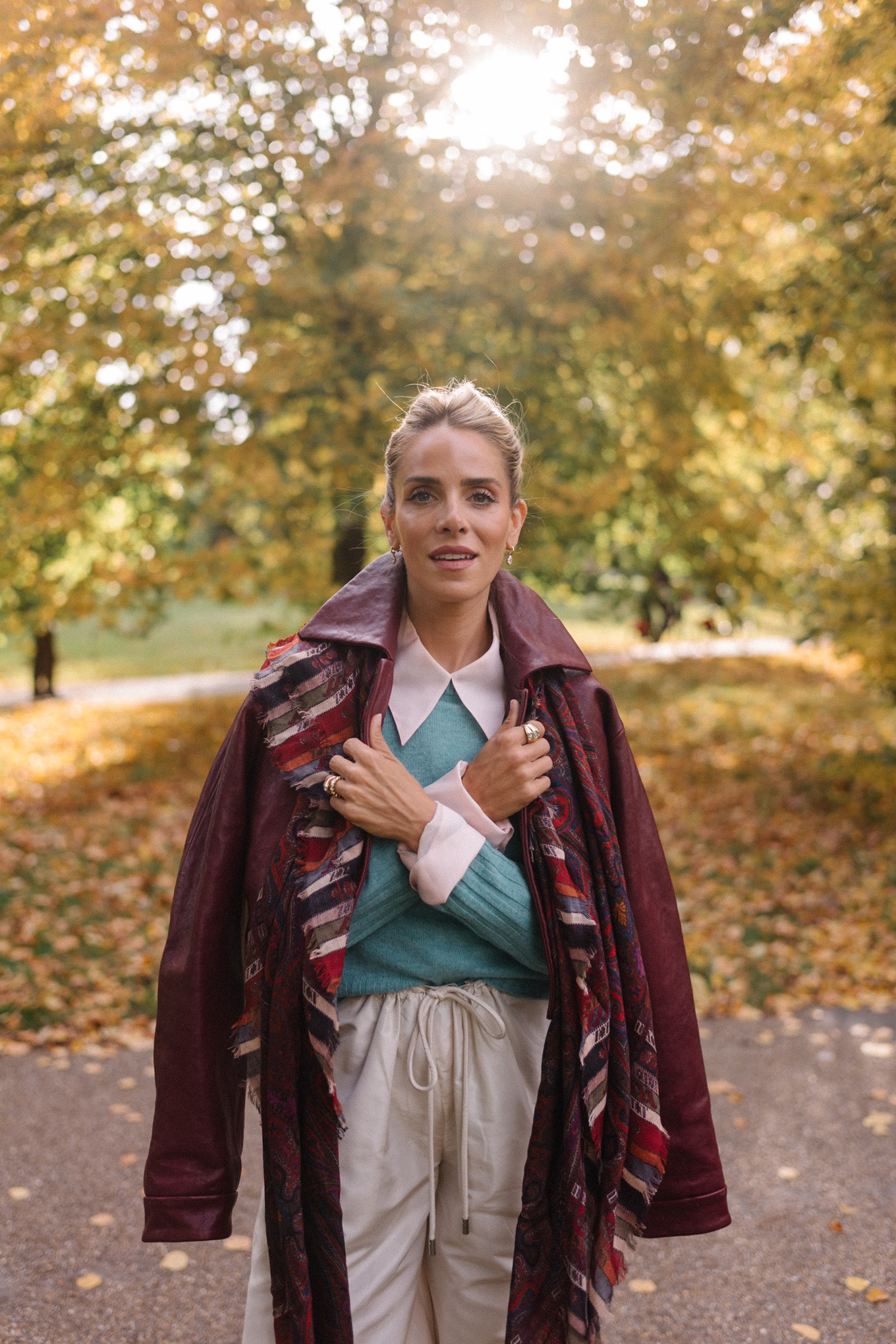 maroon leather jacket striped scarf turquoise sweater white button down shirt cream wide leg pants