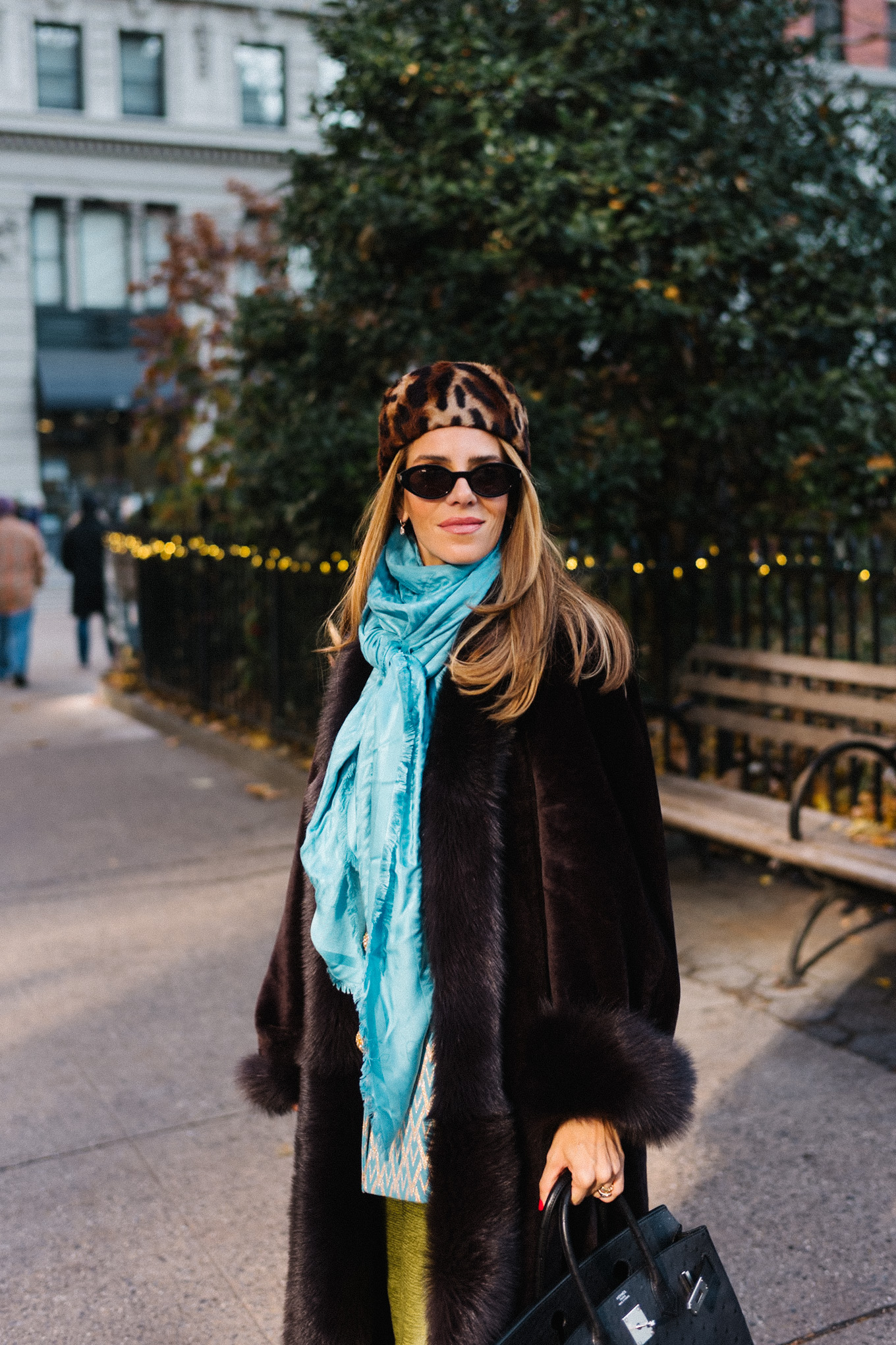 brown shearling coat leopard pill box hat green satin pants turquoise silk scarf