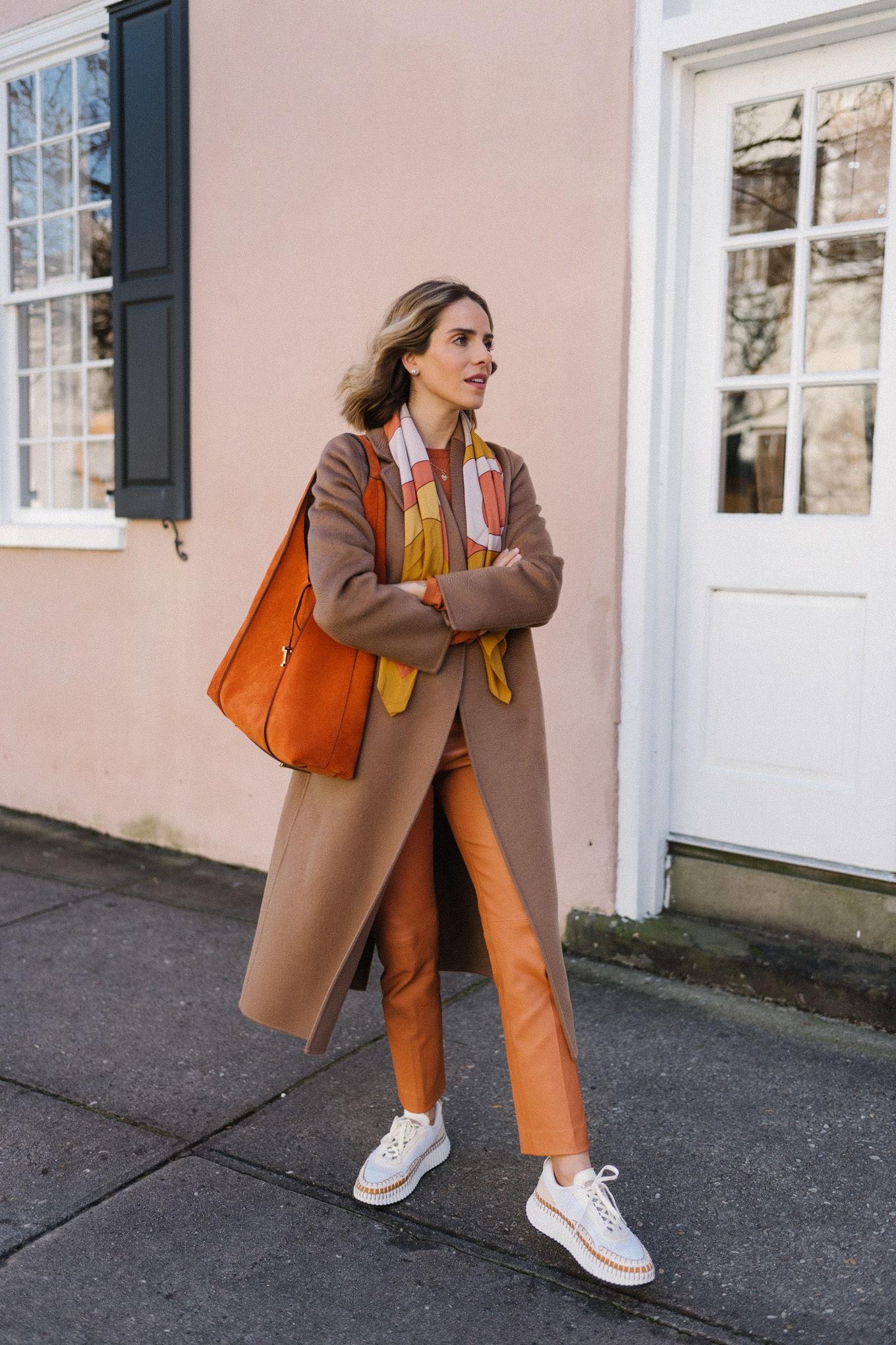 orange wool sweater leather trousers silk scarf woven sneakers