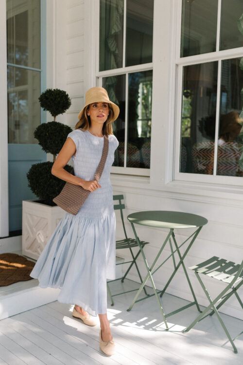 blue drop waist dress raffia bucket hat rattan ballet flats
