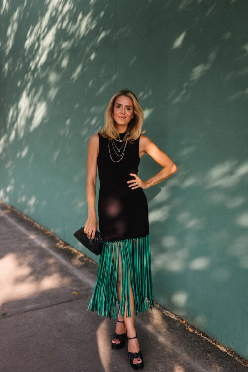 black sleeveless dress green fringe trim