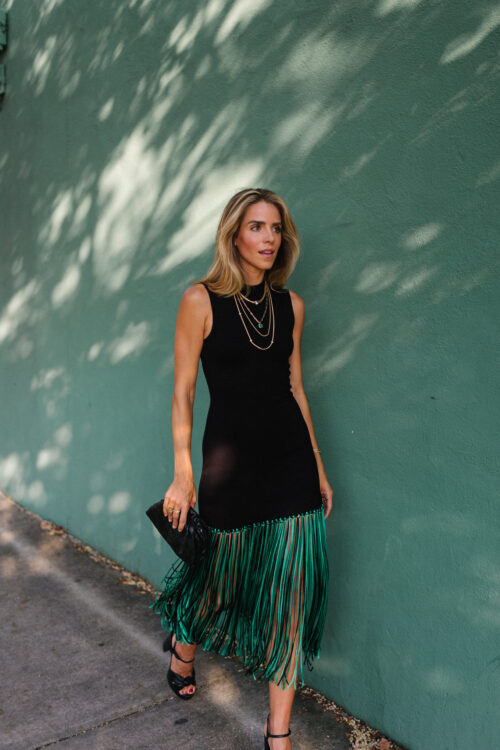 black sleeveless dress green fringe trim