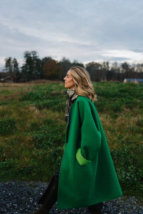 green wool coat black leather ankle pants floral tote