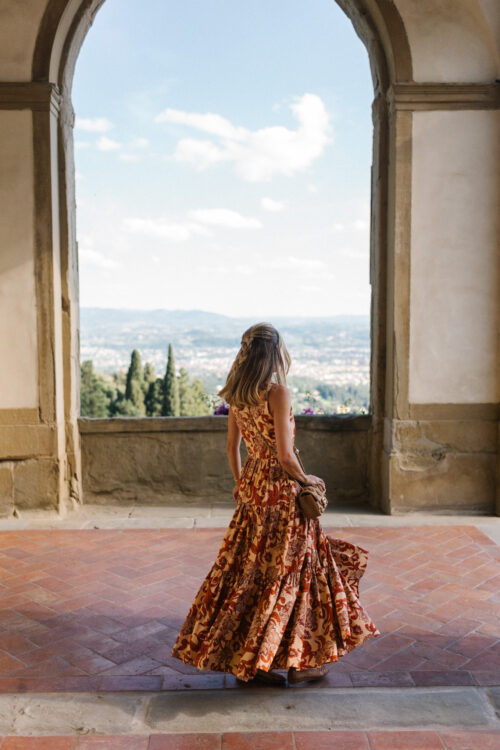 orange patterned maxi dress straw bag
