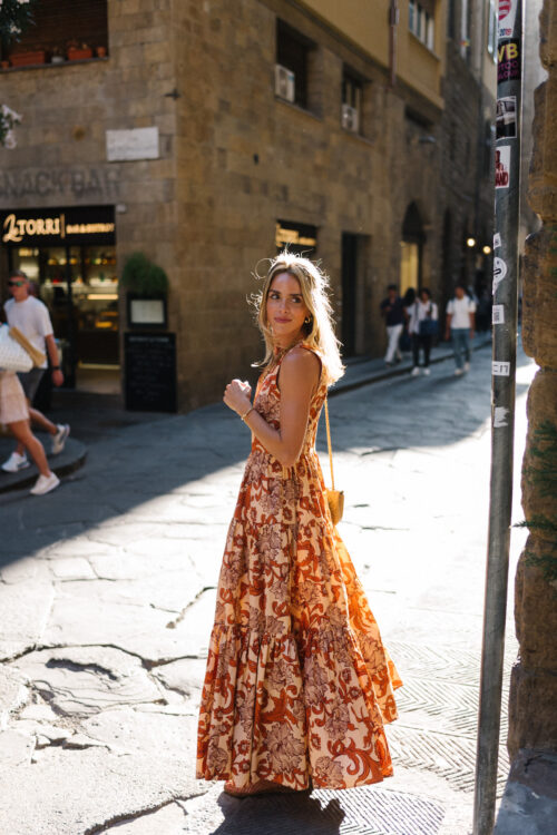orange patterned maxi dress straw bag