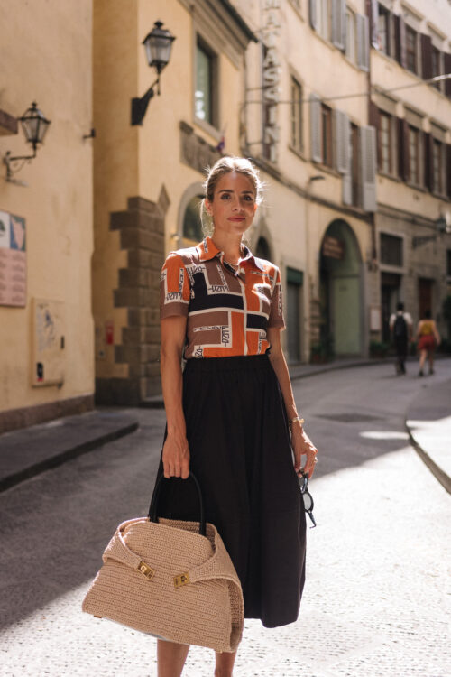 orange brown black collared shirt black skirt straw bag black leather sandals