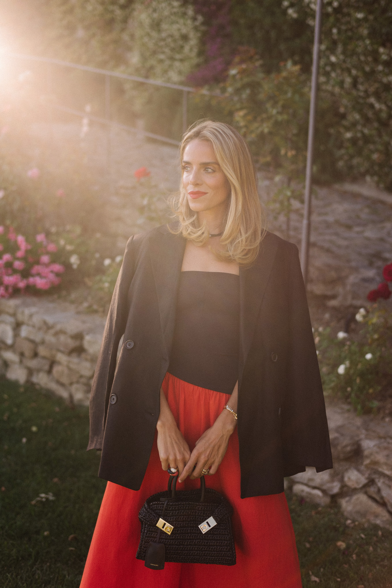 Black blazer, black and red midi dress, black straw bag, black leather sandals