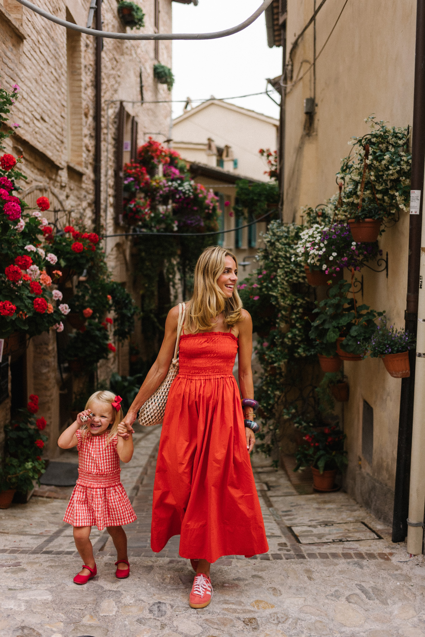 red maxi dress red sneakers woven bag