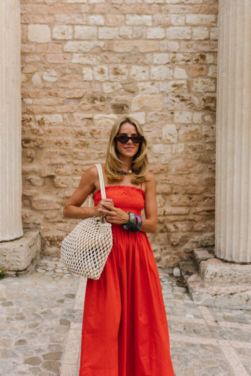 red maxi dress red sneakers woven bag