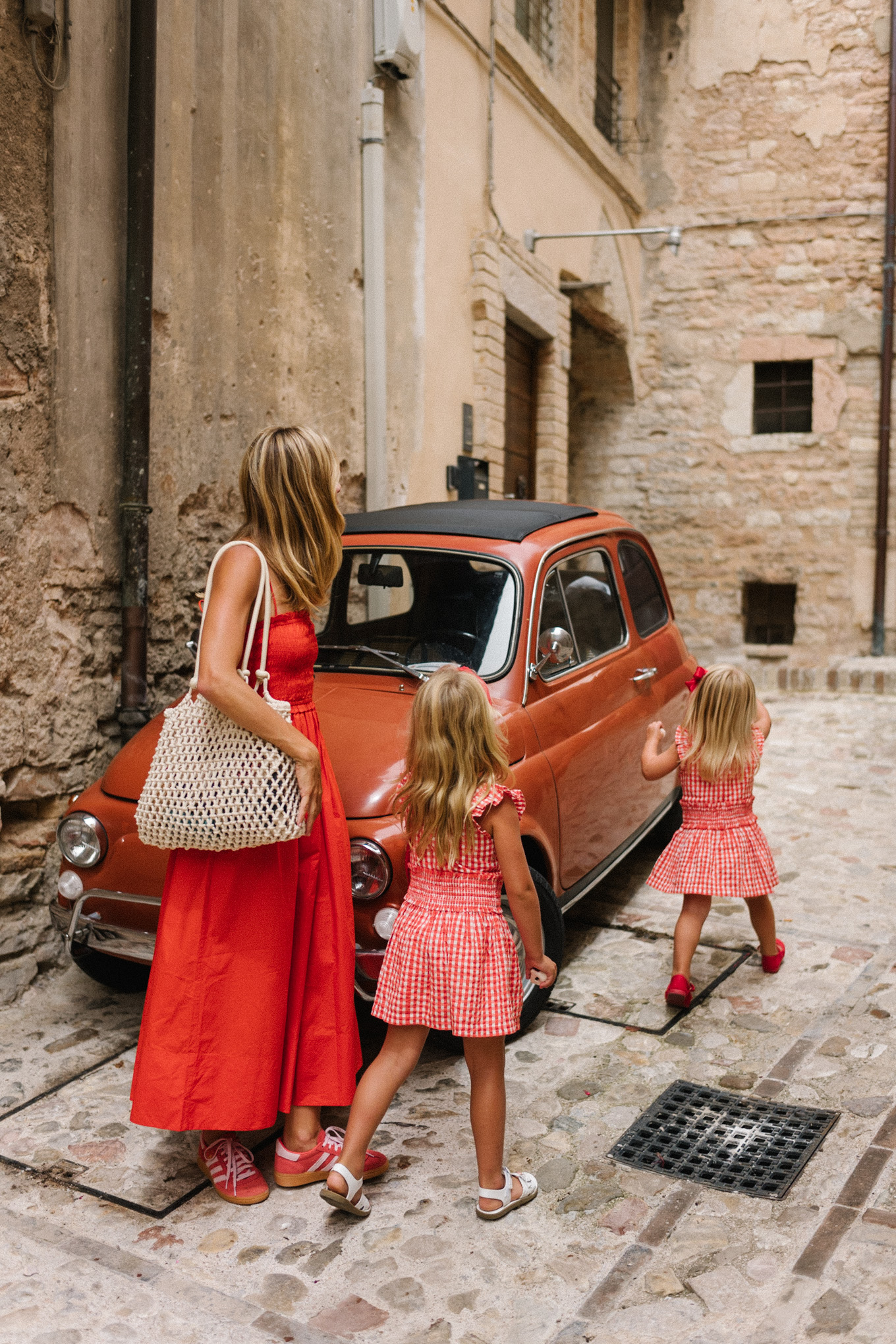 red maxi dress red sneakers woven bag