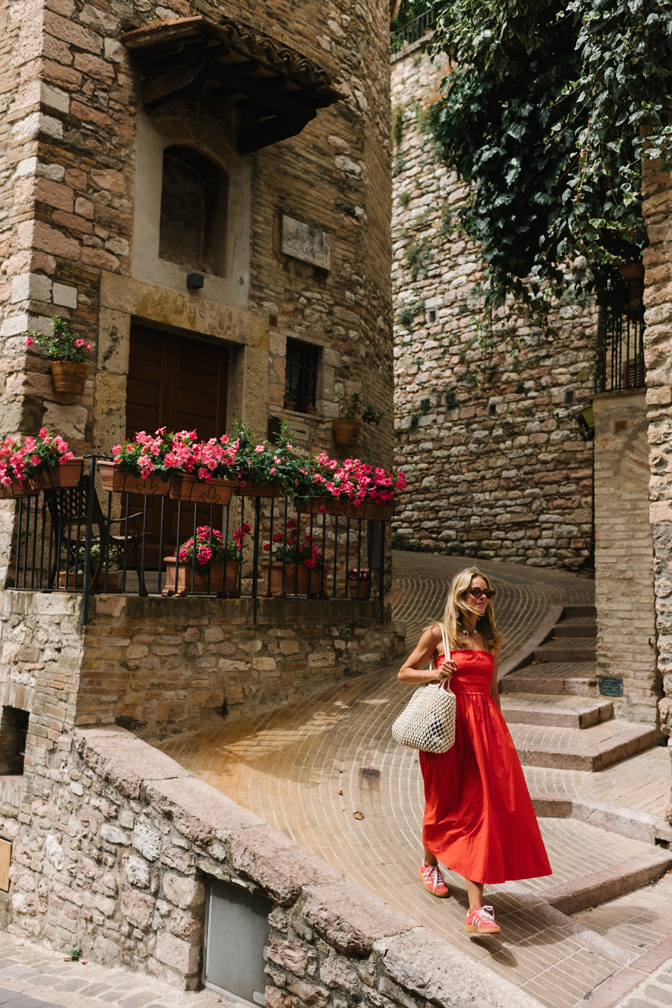 red maxi dress red sneakers woven bag