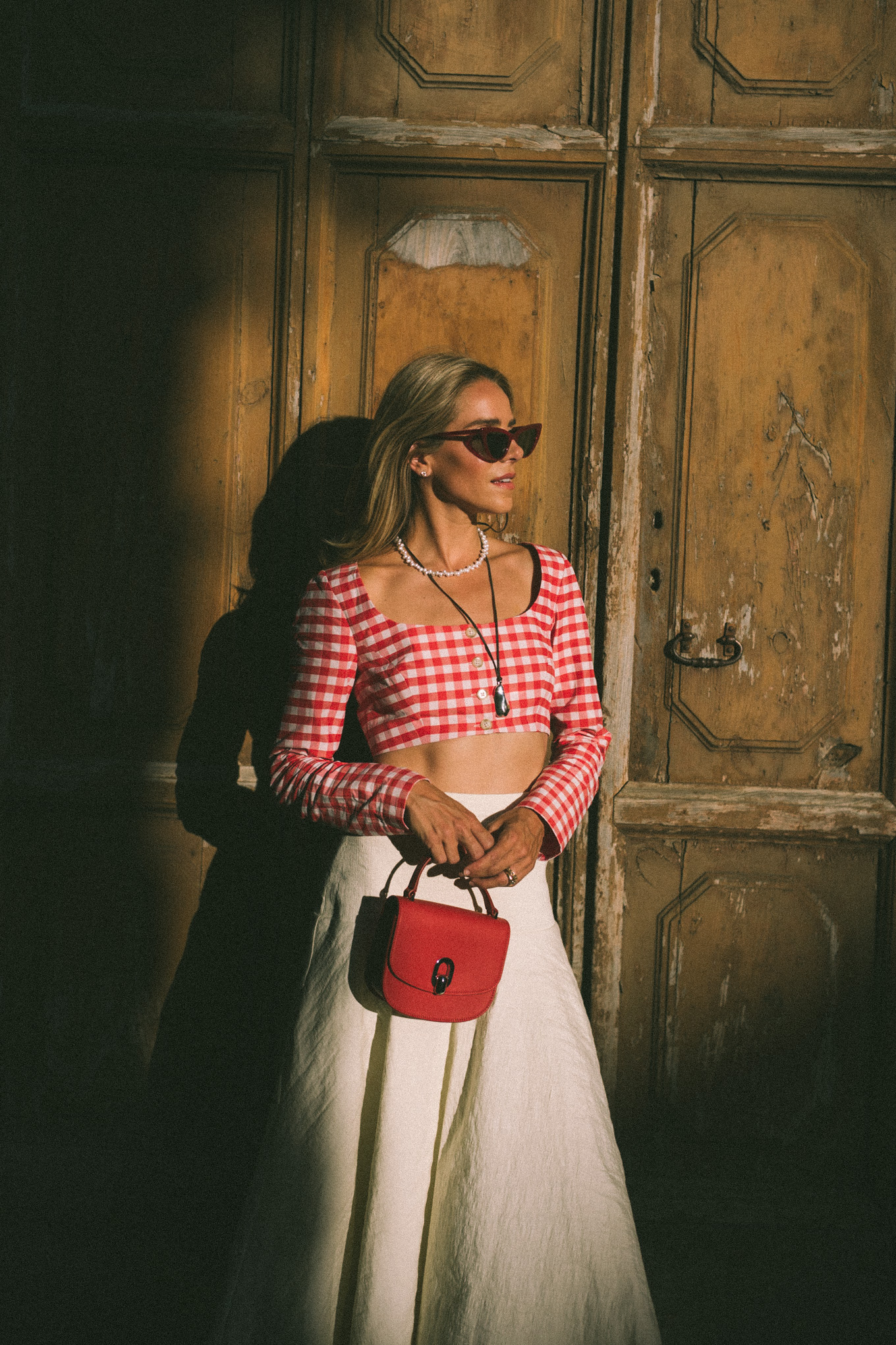 Red and white gingham crop top, white maxi skirt, red leather bag