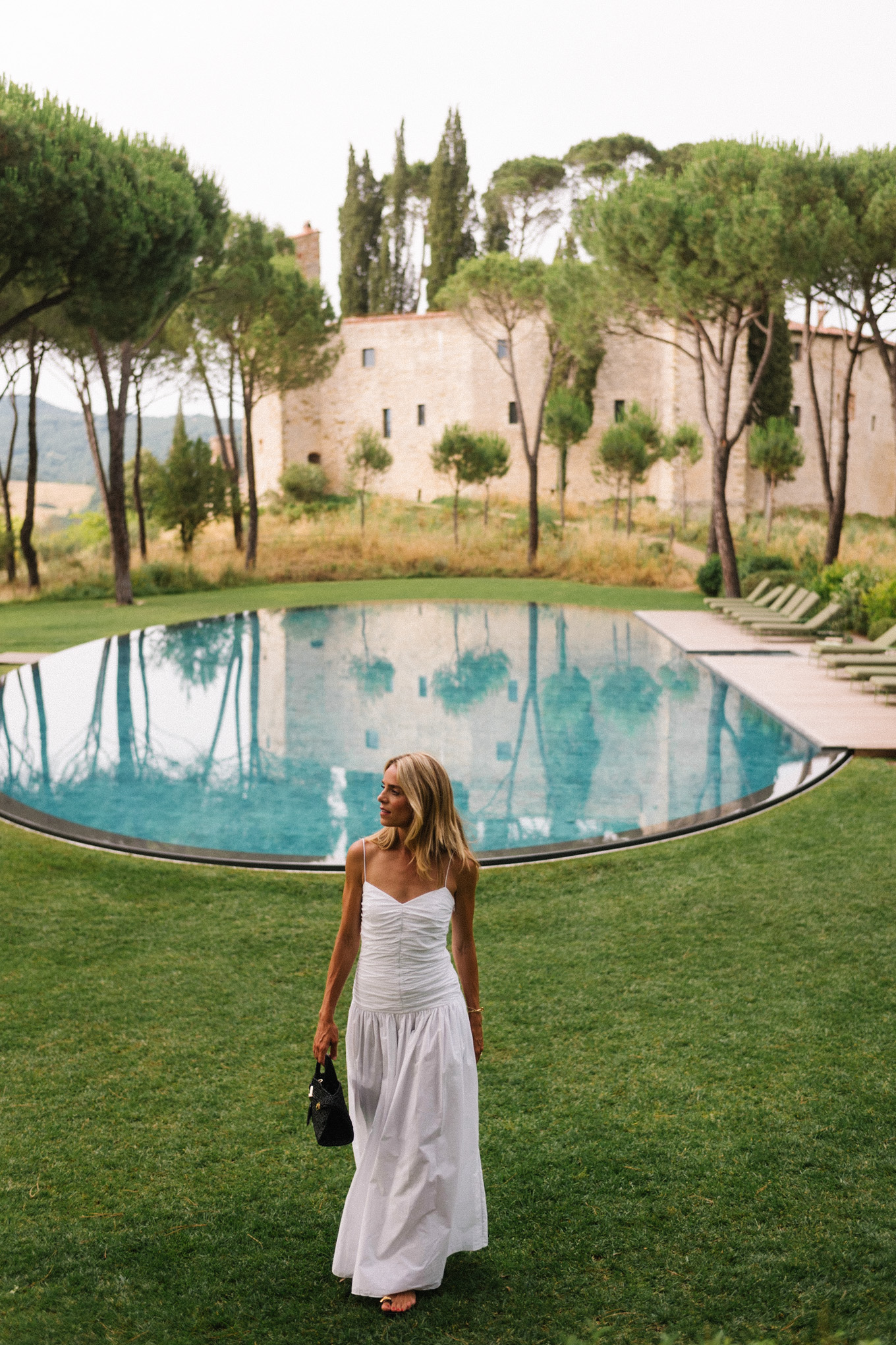 White maxi dress, black leather sandals, black straw bag