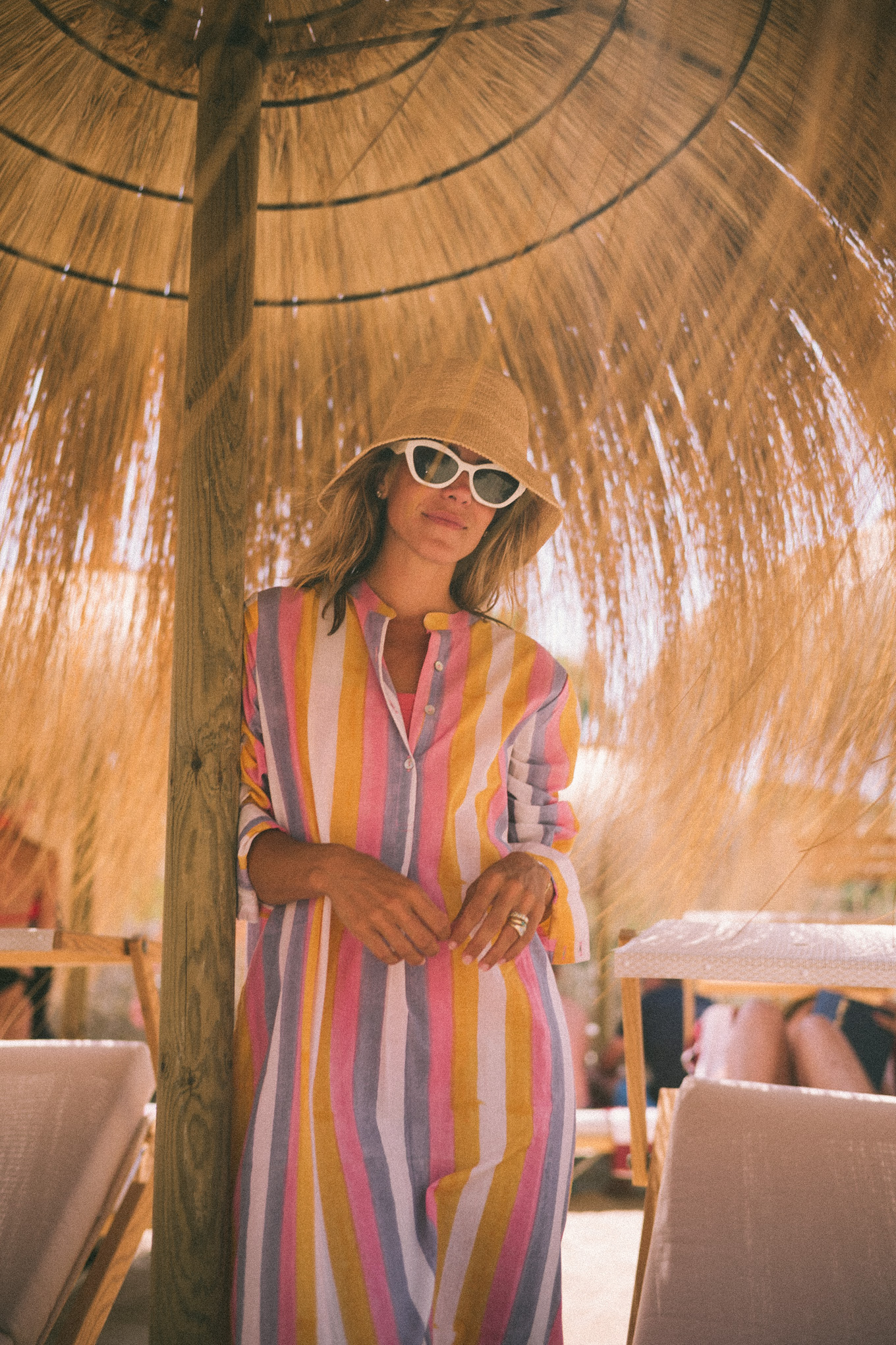 Pink and purple striped cover-up straw hat and white sunglasses