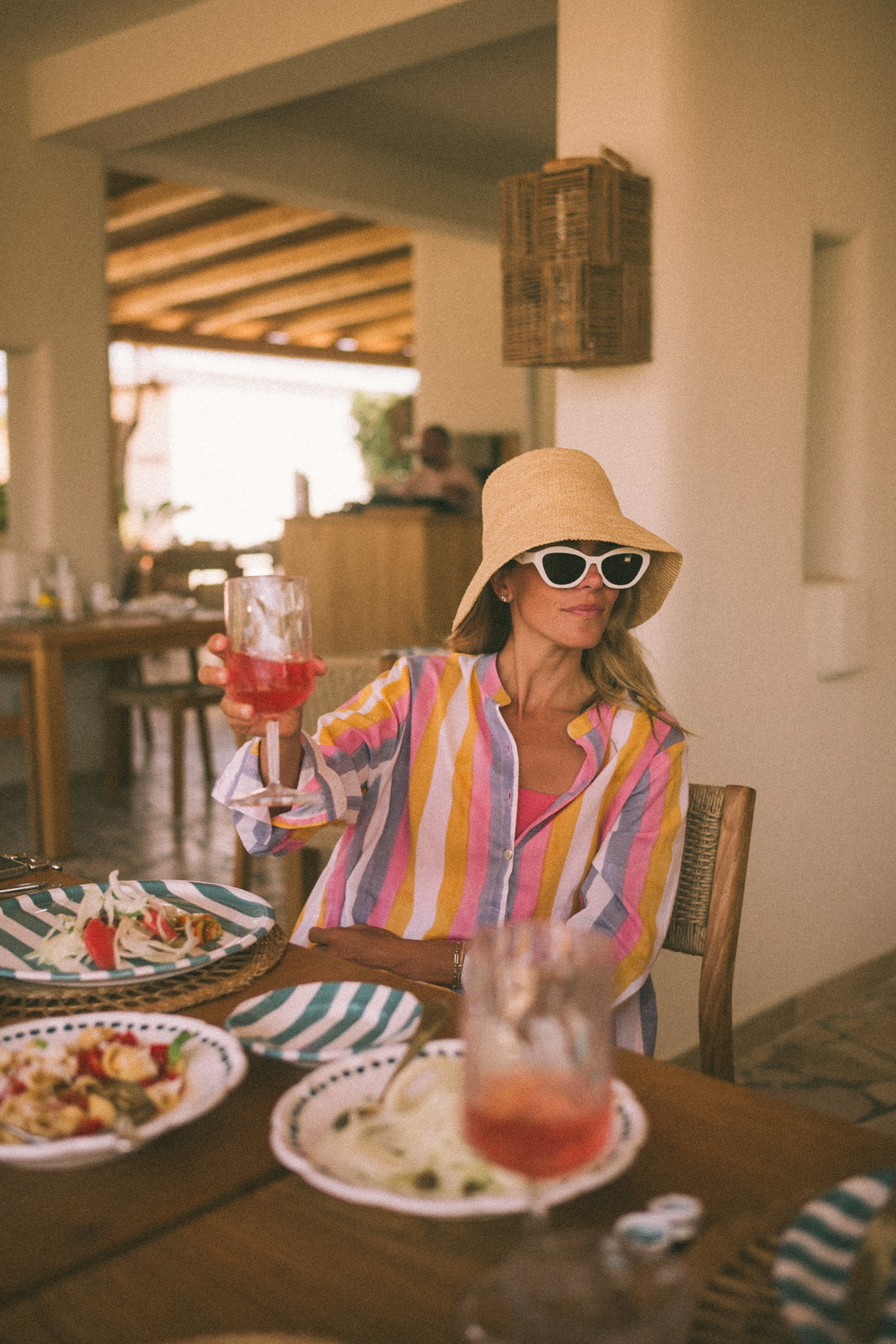 Pink and purple striped cover-up straw hat and white sunglasses