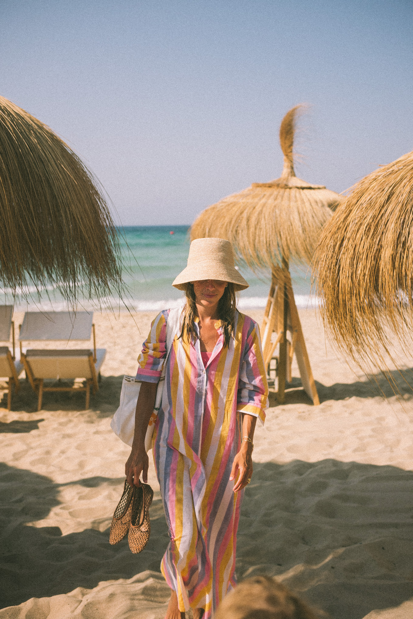 Pink and purple striped cover-up straw hat and white sunglasses