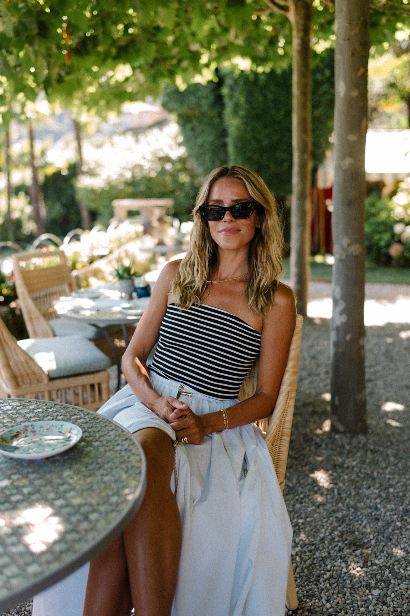 Black and white striped, strapless top, white maxi skirt, rattan flats