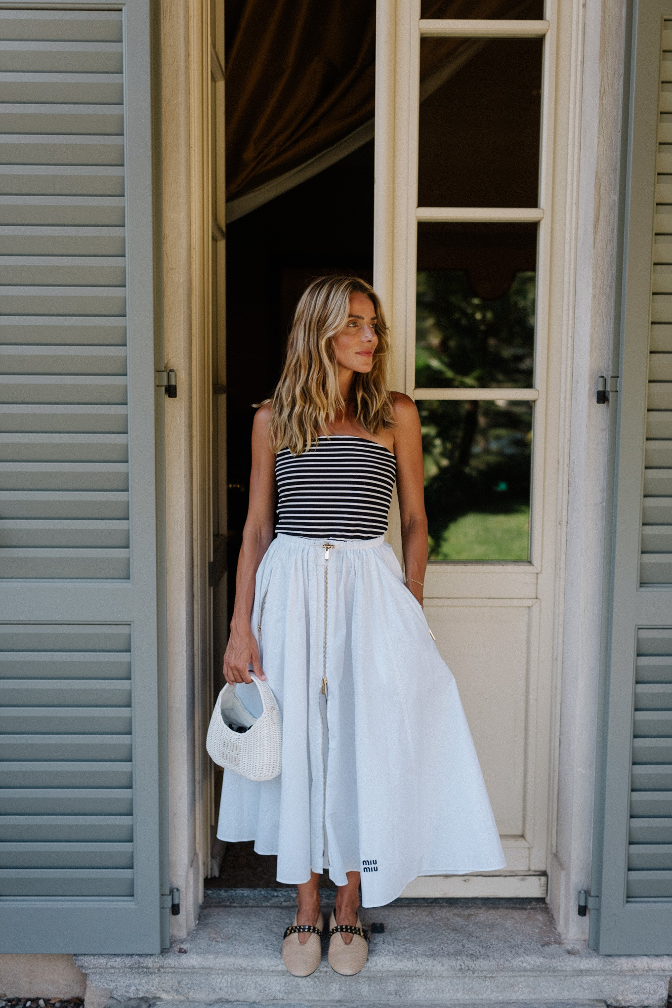 Black and white striped, strapless top, white maxi skirt, rattan flats