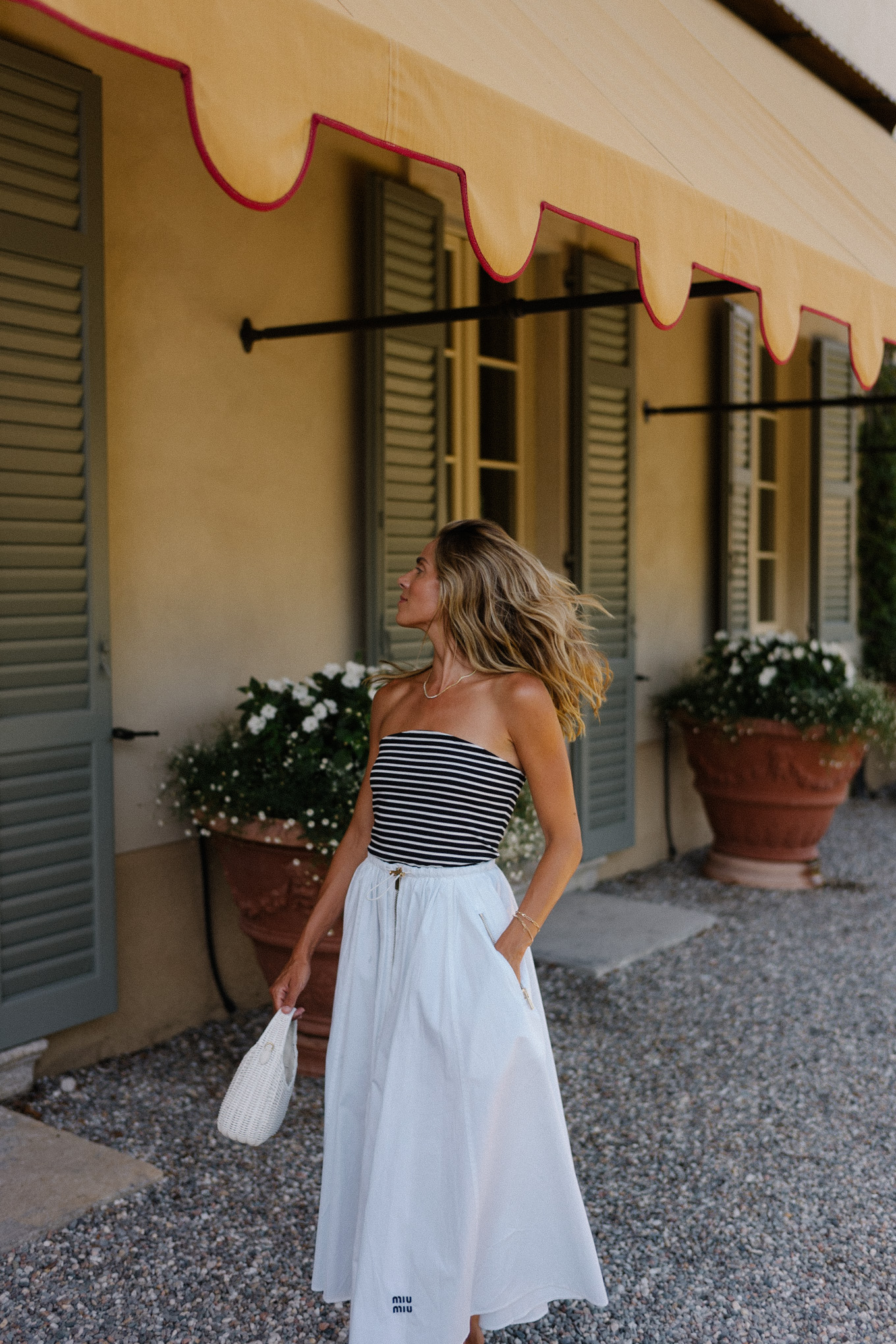 Black and white striped, strapless top, white maxi skirt, rattan flats