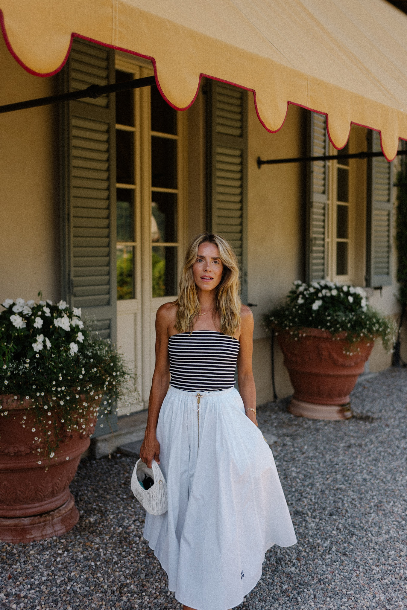 Black and white striped, strapless top, white maxi skirt, rattan flats