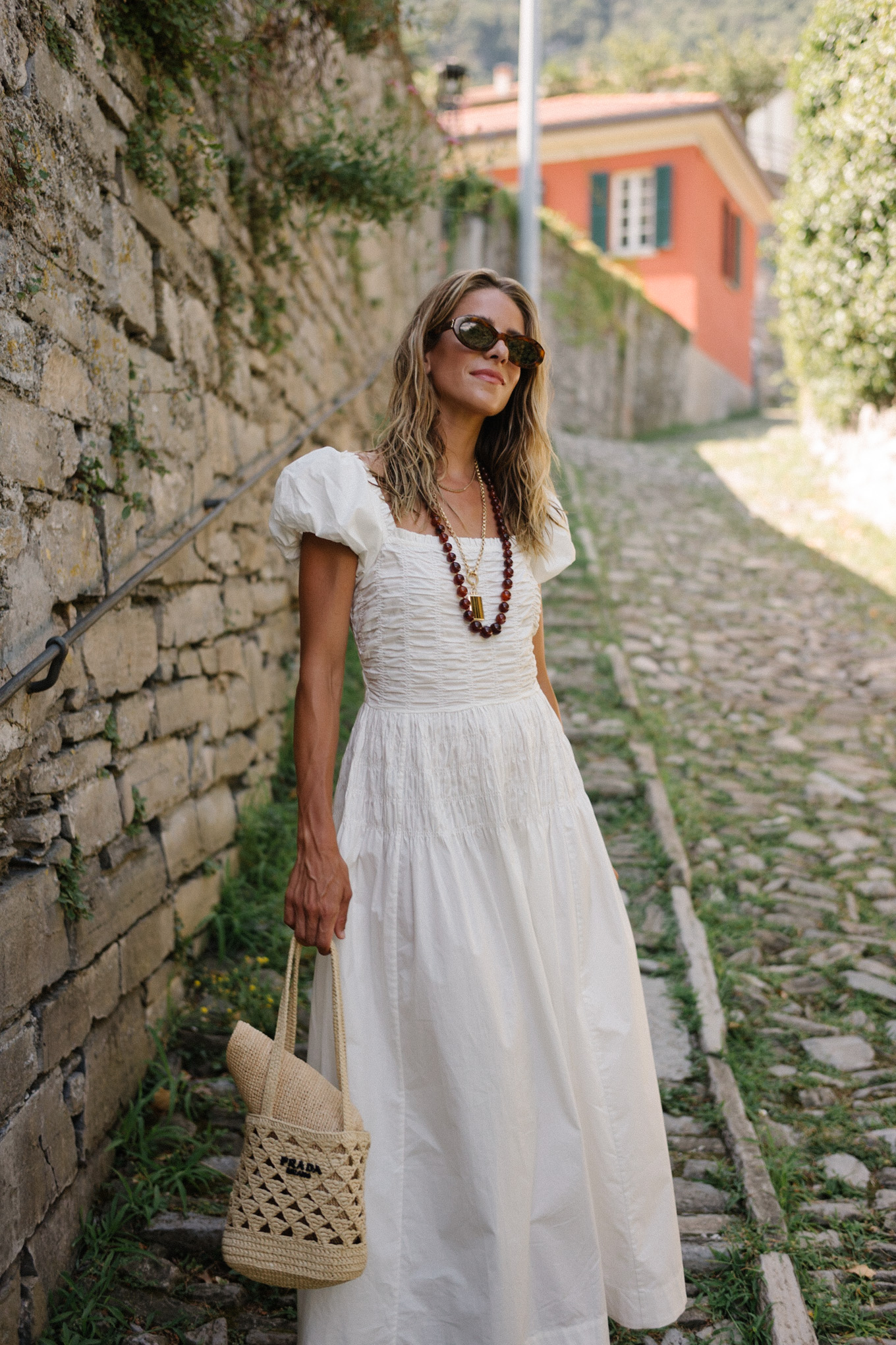 White cotton puff sleeve maxi dress with brown beaded necklace