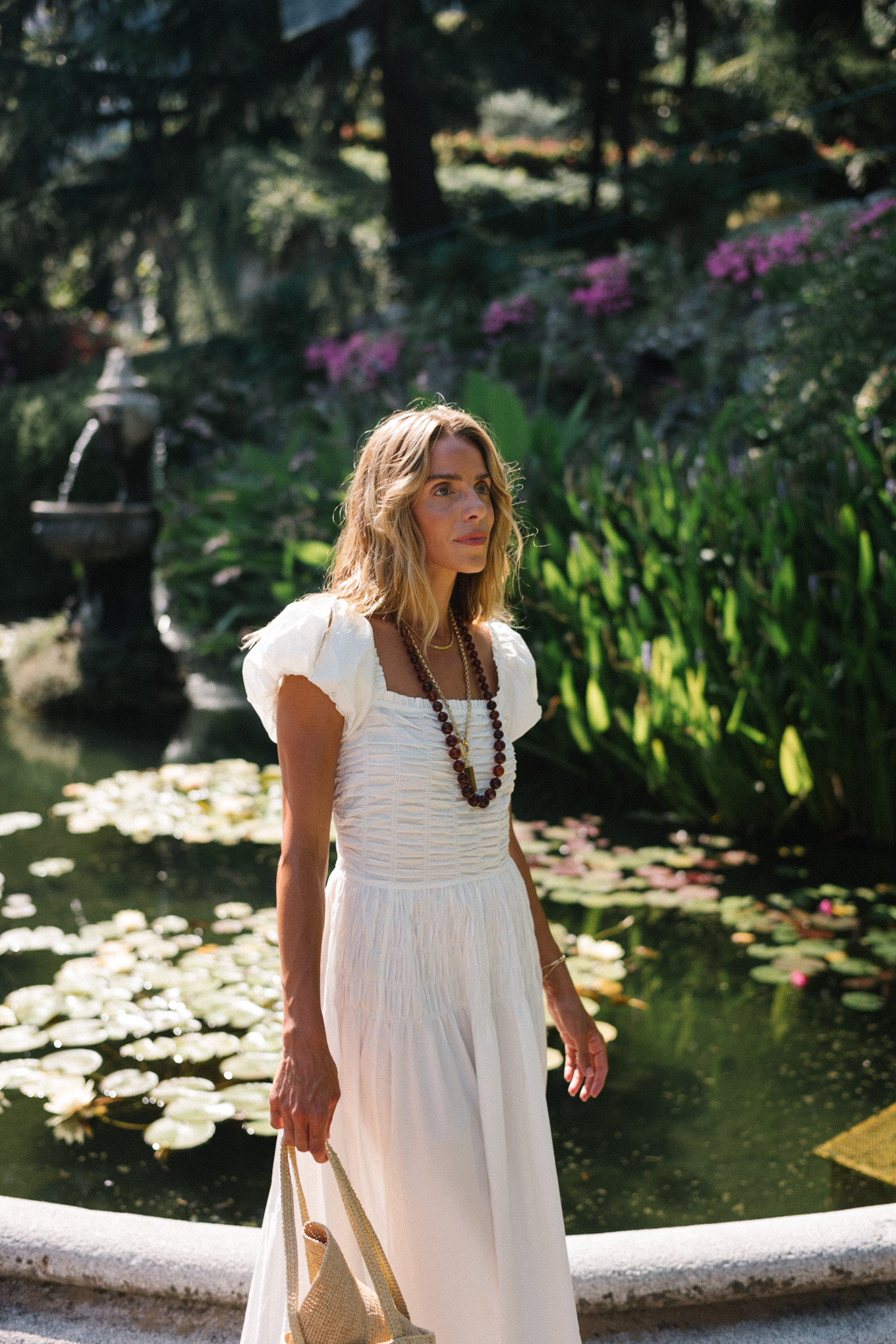 White cotton puff sleeve maxi dress with brown beaded necklace