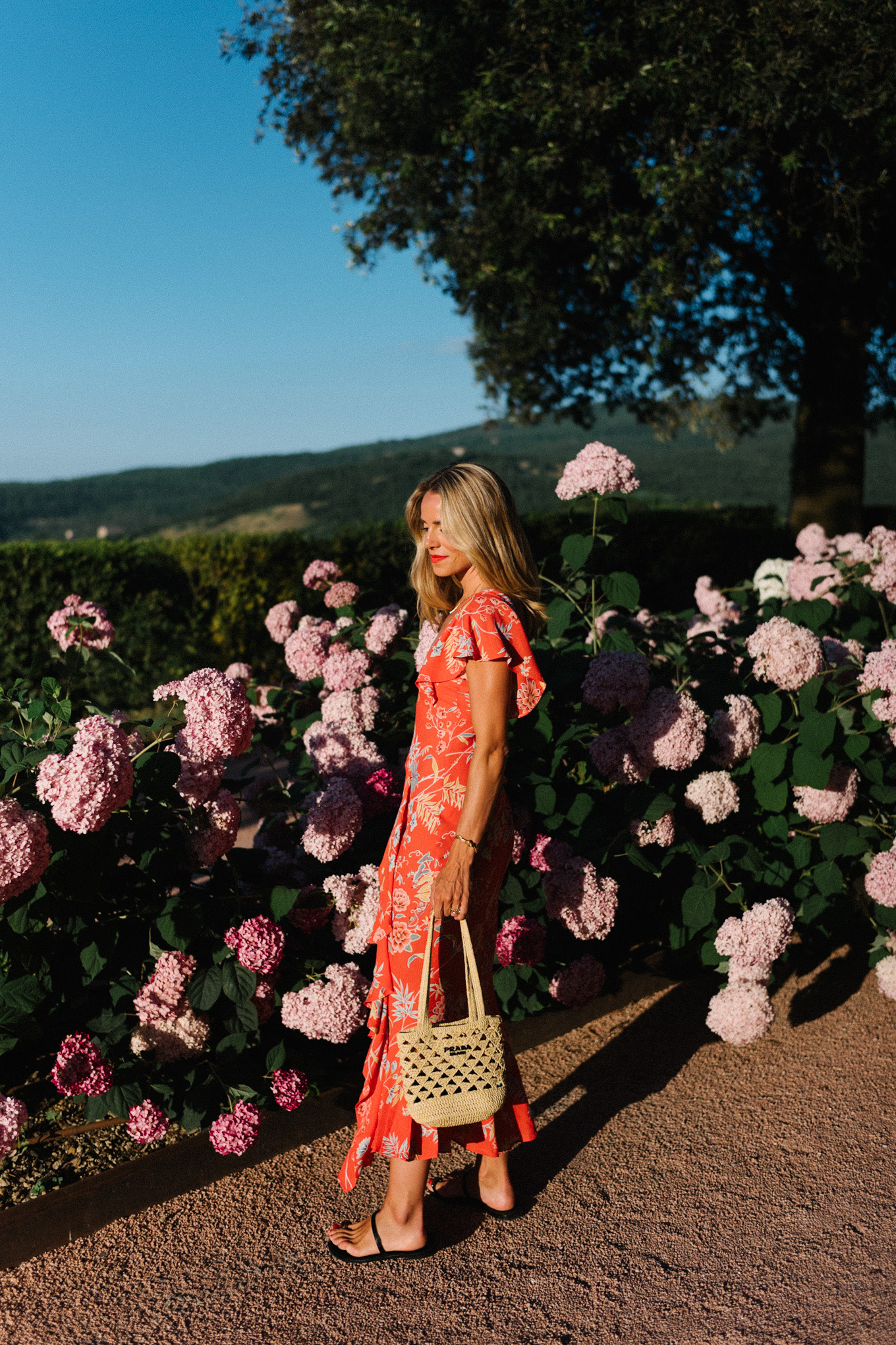 red floral midi dress straw bag