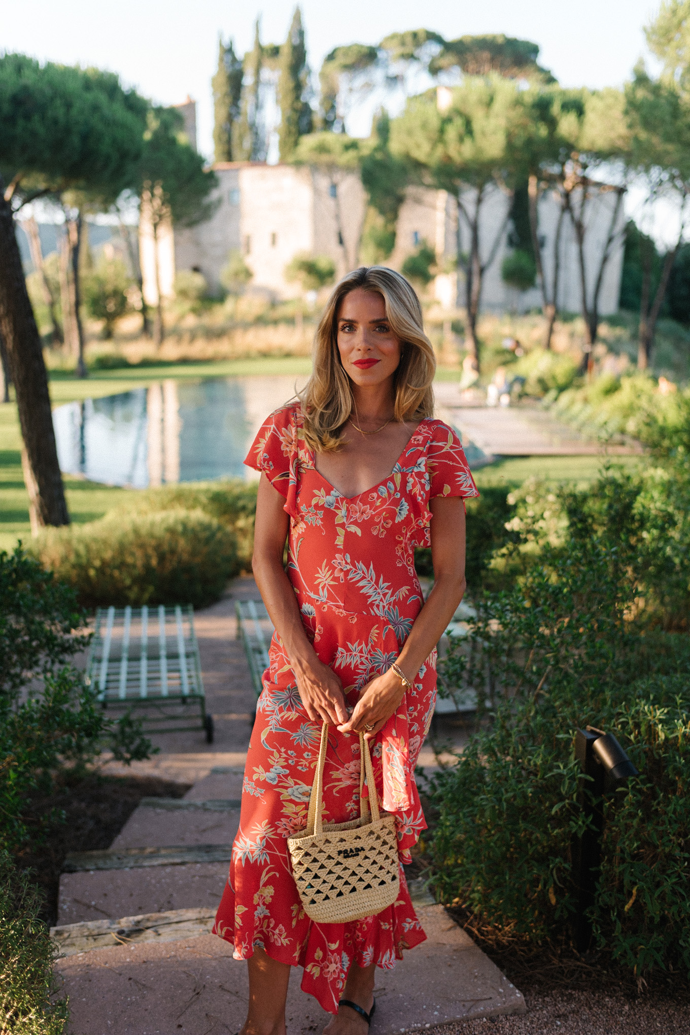 red floral midi dress straw bag