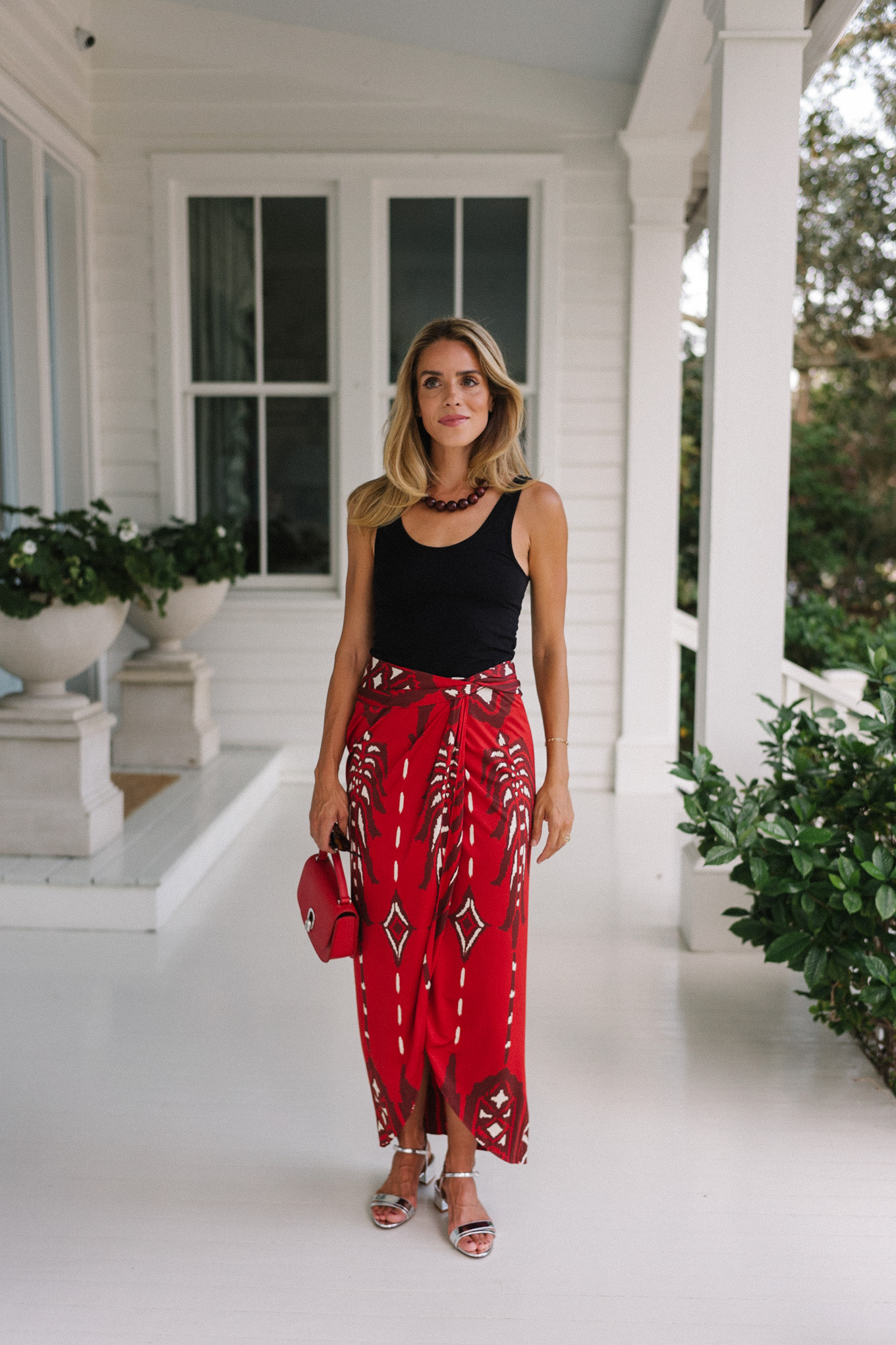 Black tank top, red maxi wrap skirt, silver heels, red bag