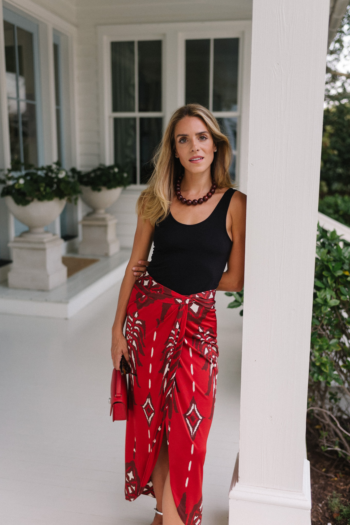 Black tank top, red maxi wrap skirt, silver heels, red bag