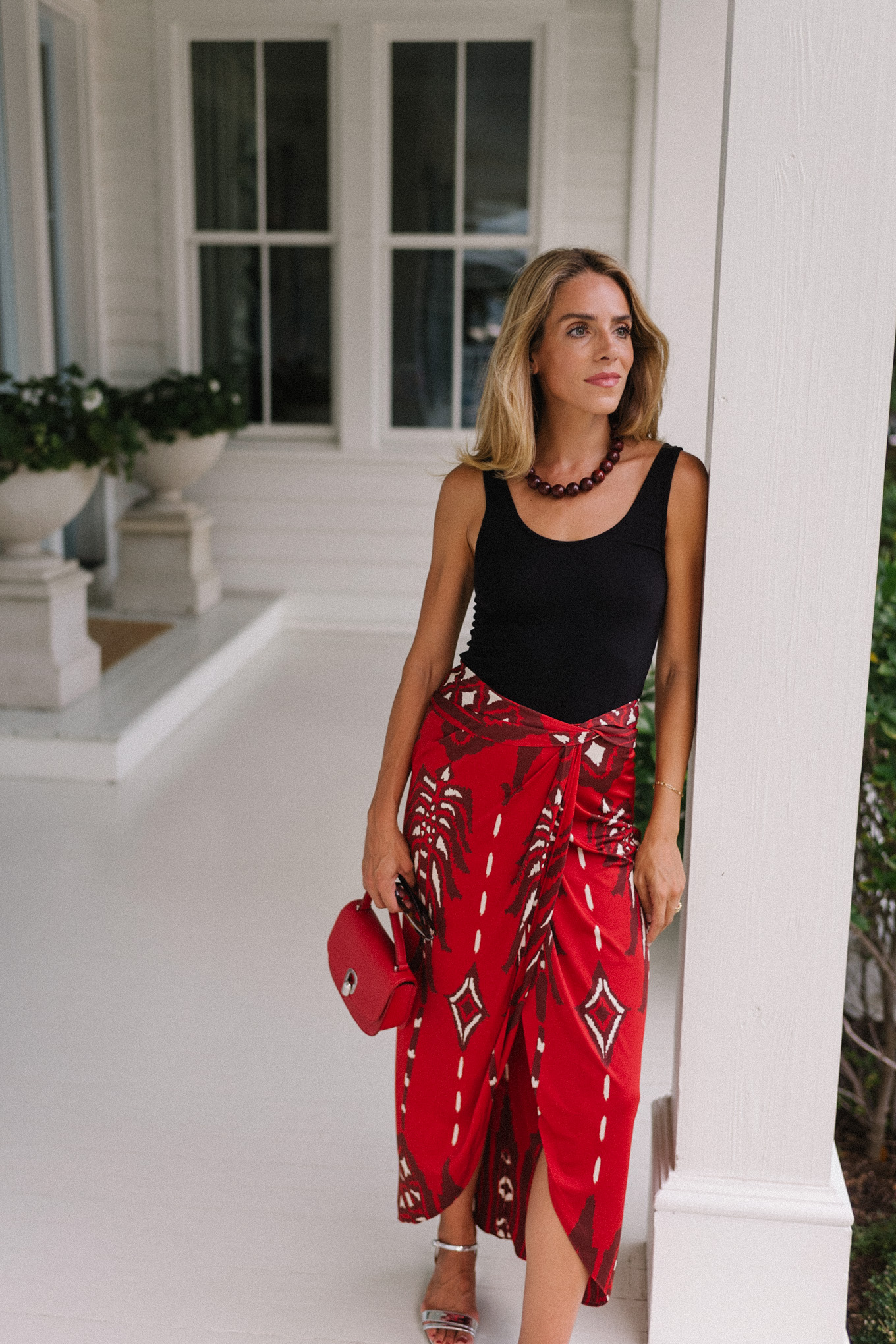 Black tank top, red maxi wrap skirt, silver heels, red bag