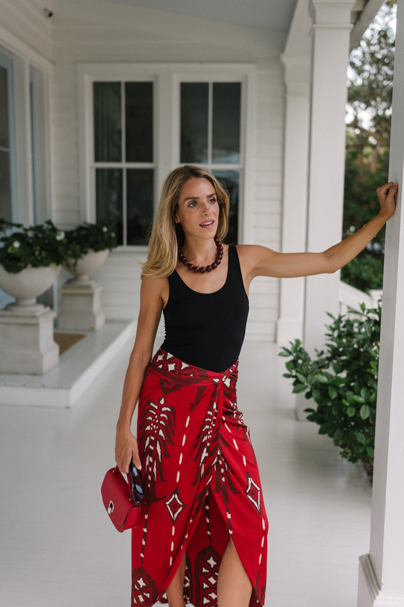 Black tank top, red maxi wrap skirt, silver heels, red bag