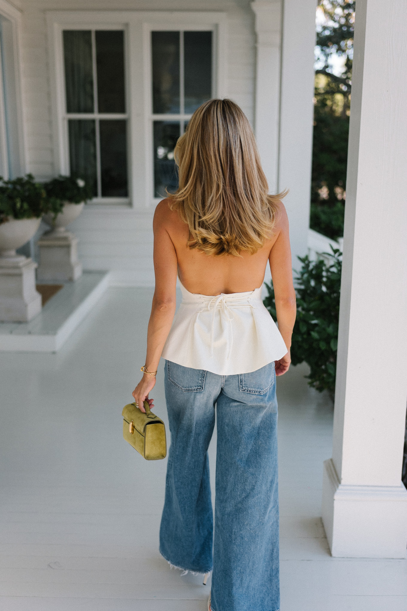 Cream silk halter top, wide leg denim and chartreuse handbag