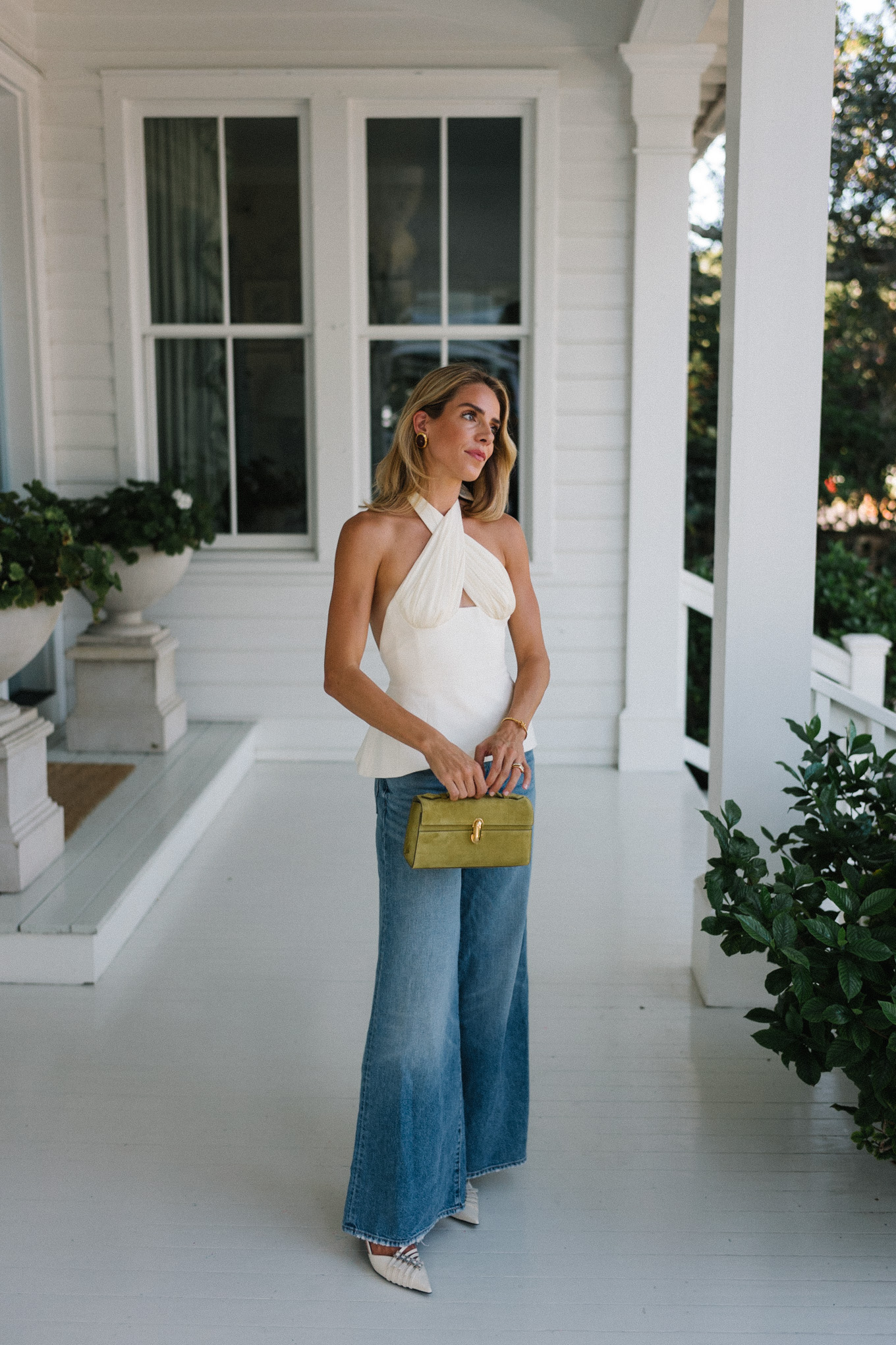 Cream silk halter top, wide leg denim and chartreuse handbag