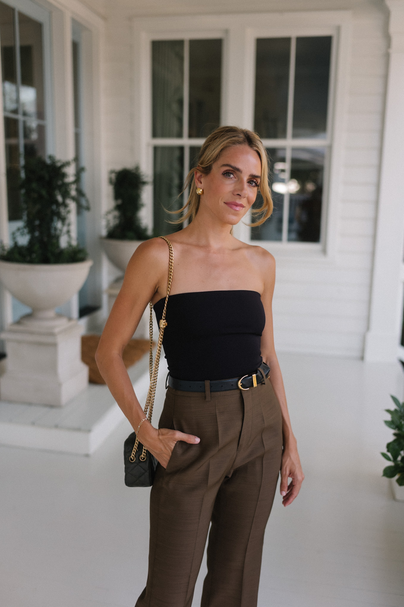 Strapless black top, brown silk trousers, maroon patent leather slingback high heels