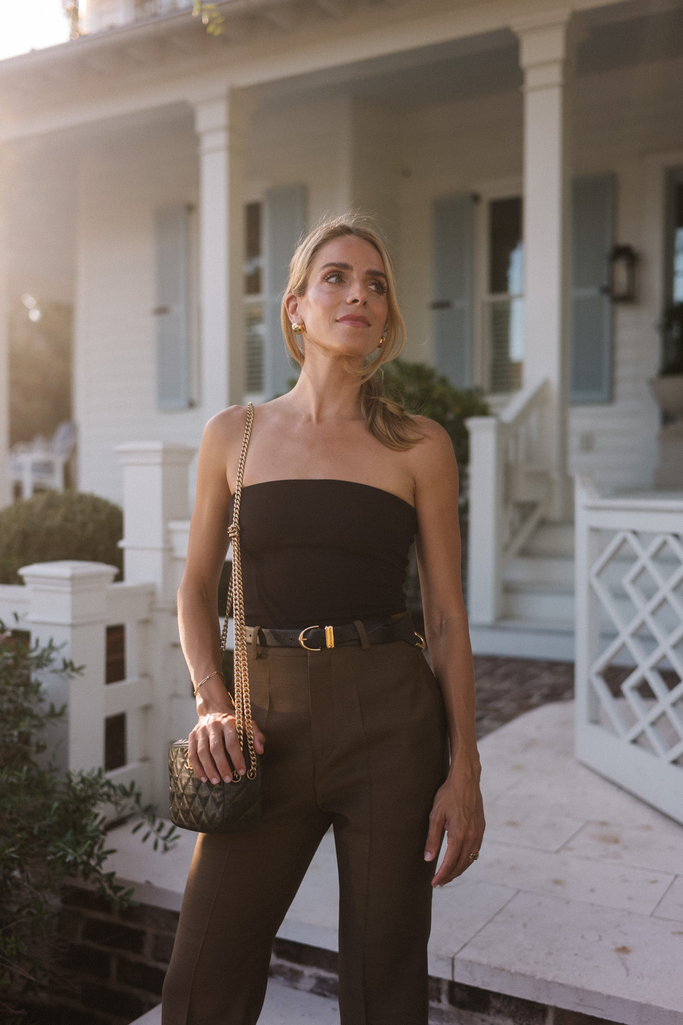 Strapless black top, brown silk trousers, maroon patent leather slingback high heels