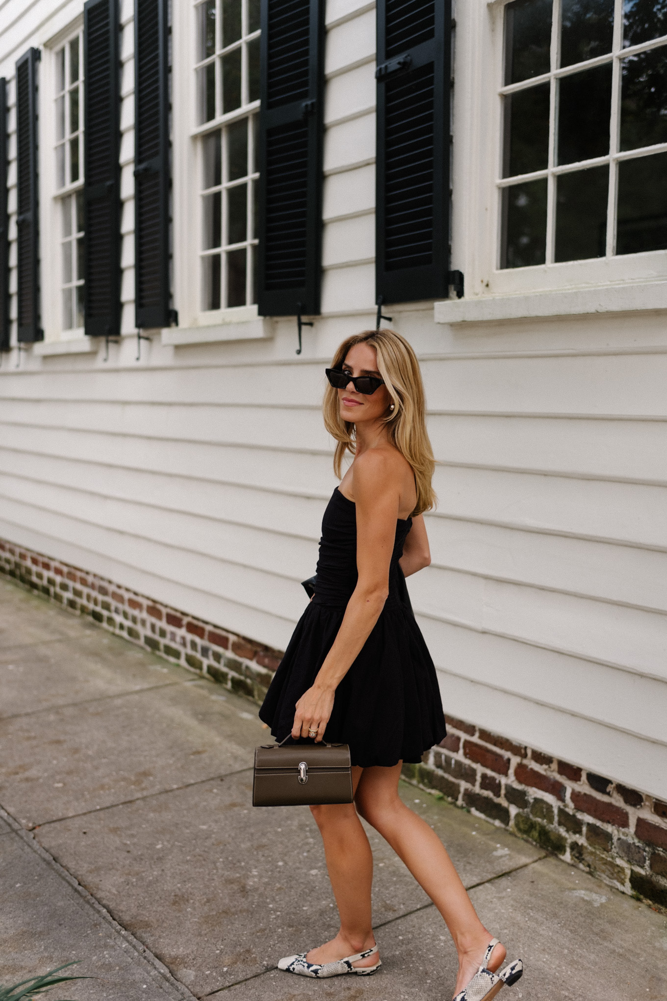 Black mini dress, black leather jacket, snakeskin mules, leather bag