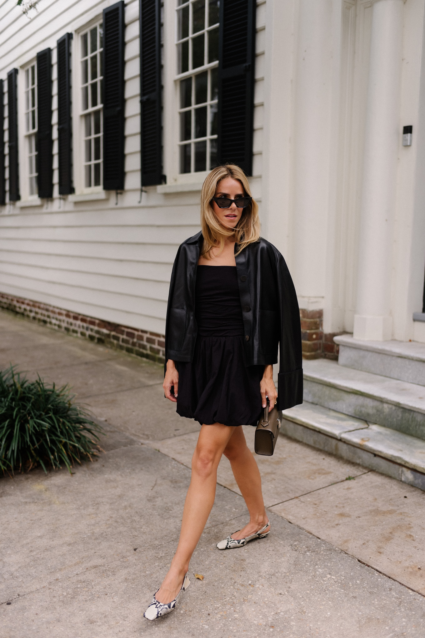 Black mini dress, black leather jacket, snakeskin mules, leather bag