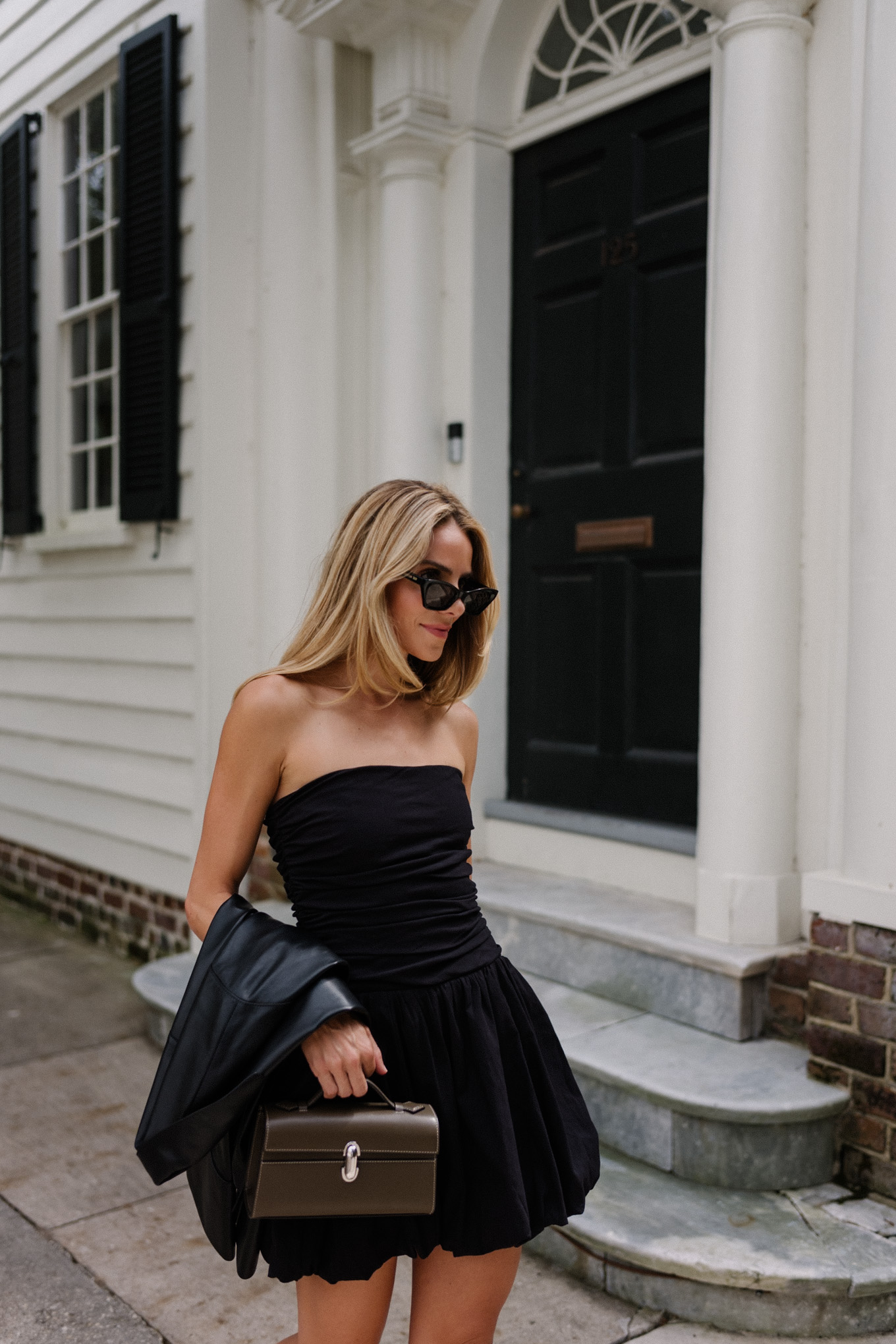 Black mini dress, black leather jacket, snakeskin mules, leather bag