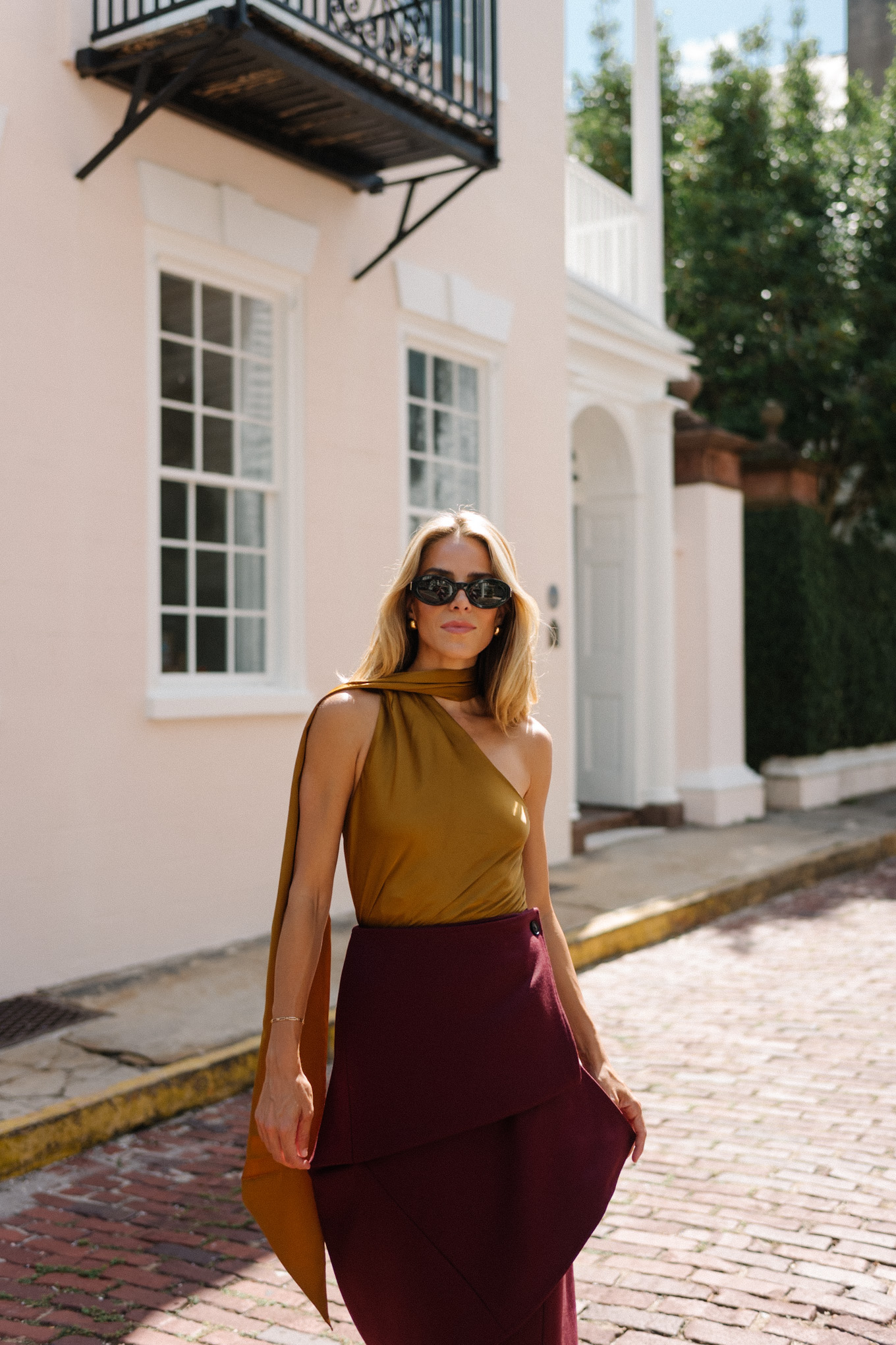 Burgundy leather jacket, burgundy midi skirt, gold silk shirt