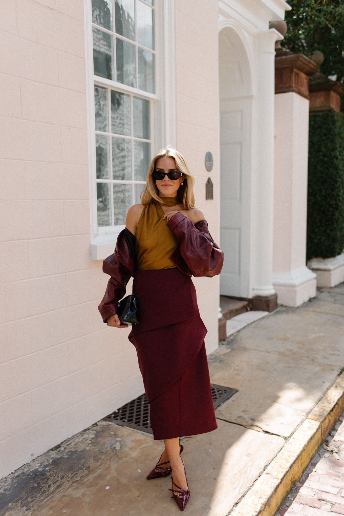 Burgundy leather jacket, burgundy midi skirt, gold silk shirt