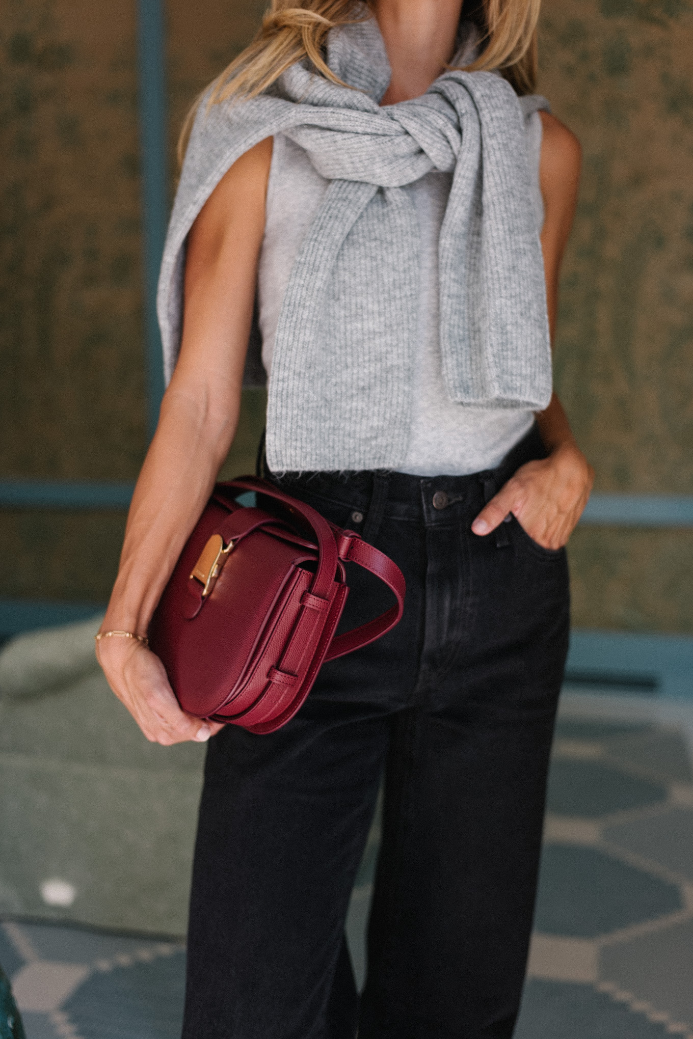 grey sweater black denim jeans burgundy handbag