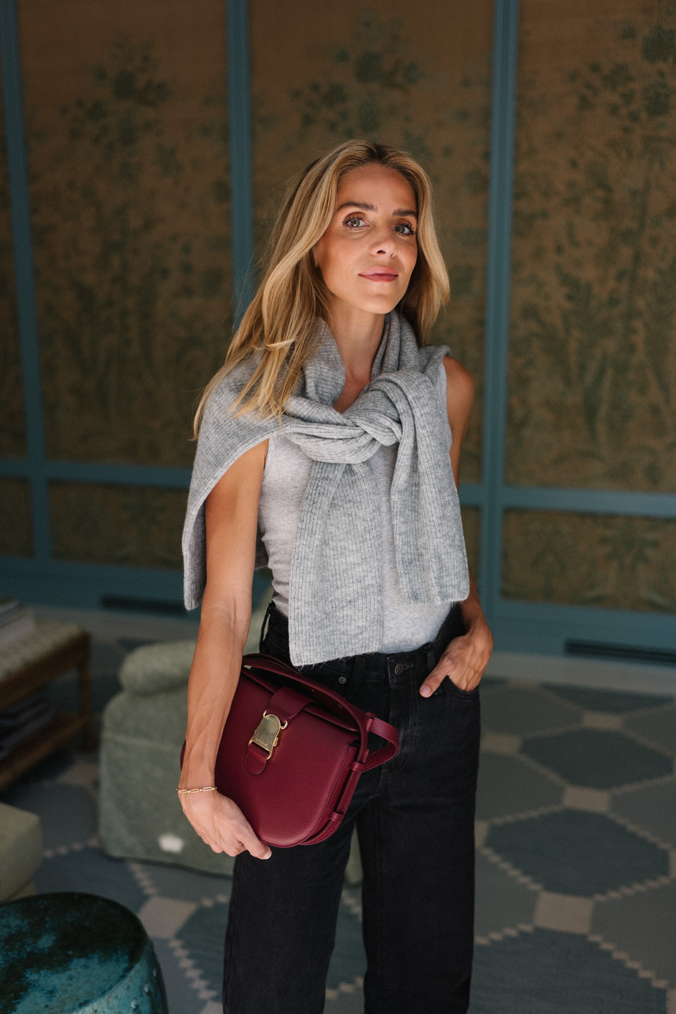 grey sweater black denim jeans burgundy handbag