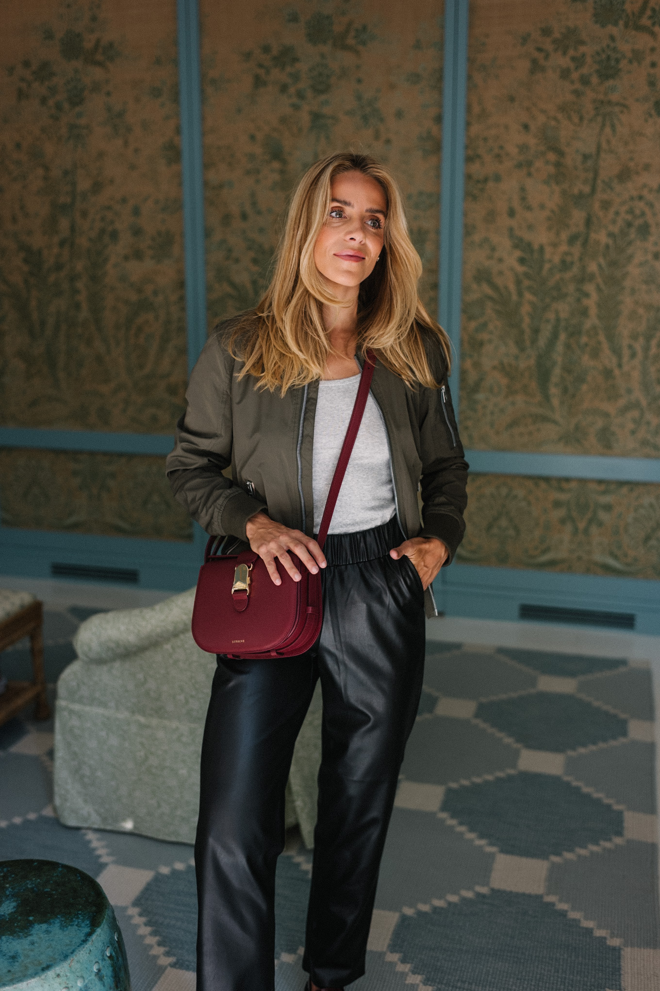 green military jacket black leather pants burgundy handbag