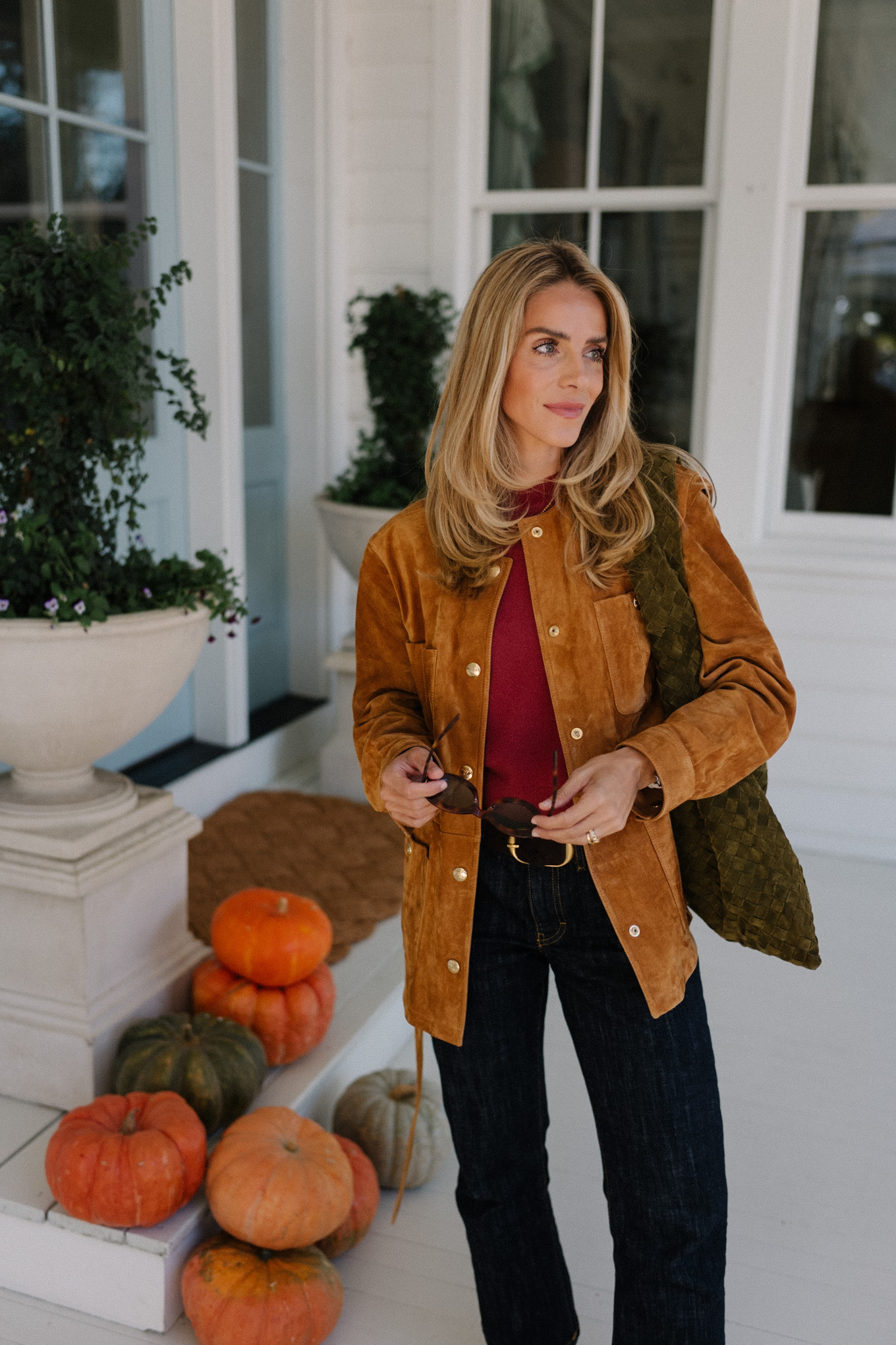 brown suede jacket red sweater dark denim jeans brown flats