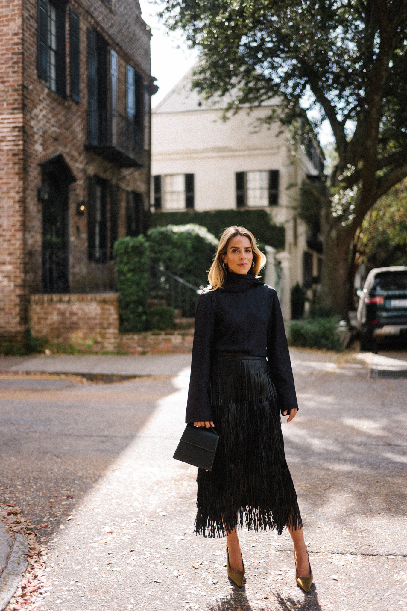 black silk wrap blouse black leather fringe skirt chartreuse pumps black leather handbag