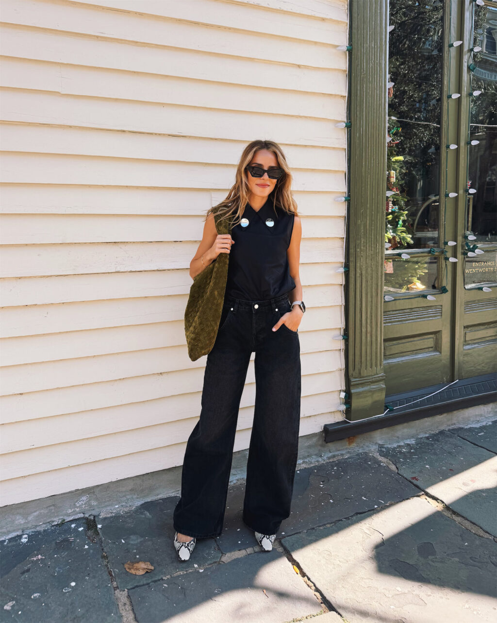 Black silk top, black loose jeans, snakeskin high heels