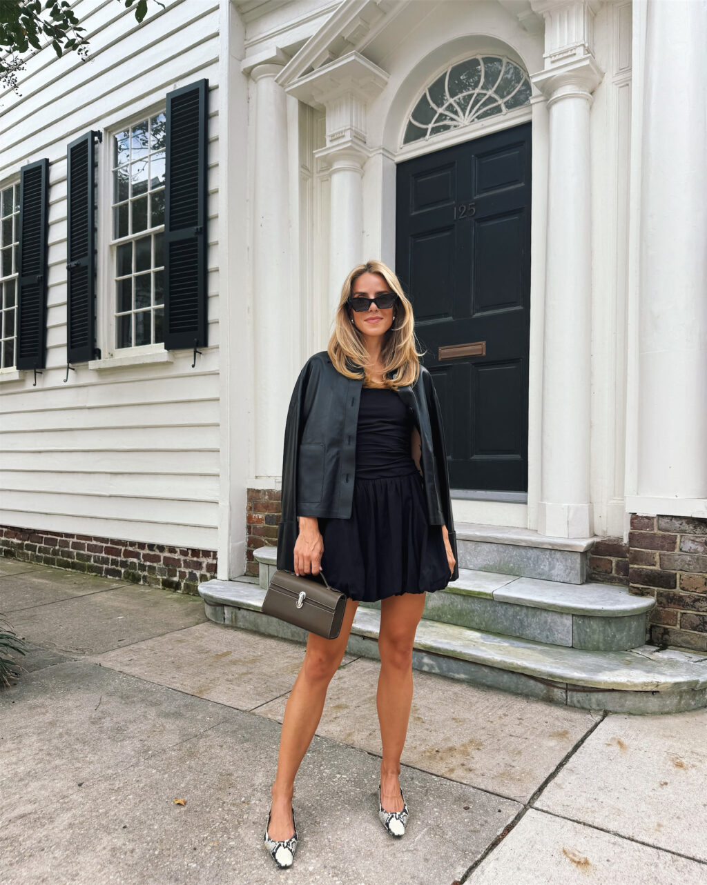 Black leather jacket, black mini dress, snakeskin heels